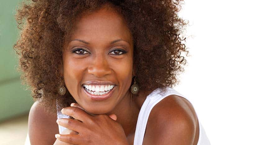 black-woman-with-frizzy-hair-and-a-bright-smile-looking-right-at-you