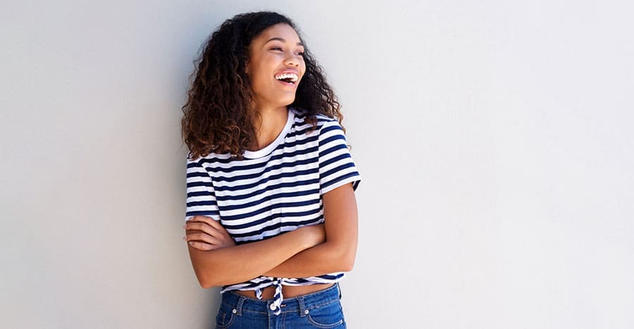 young-black-woman-with-curly-hair-smiling-and-laughing