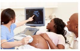 nurse-is-checking-pregnant-woman-using-sonogram-equipment-as-husband-looks-on